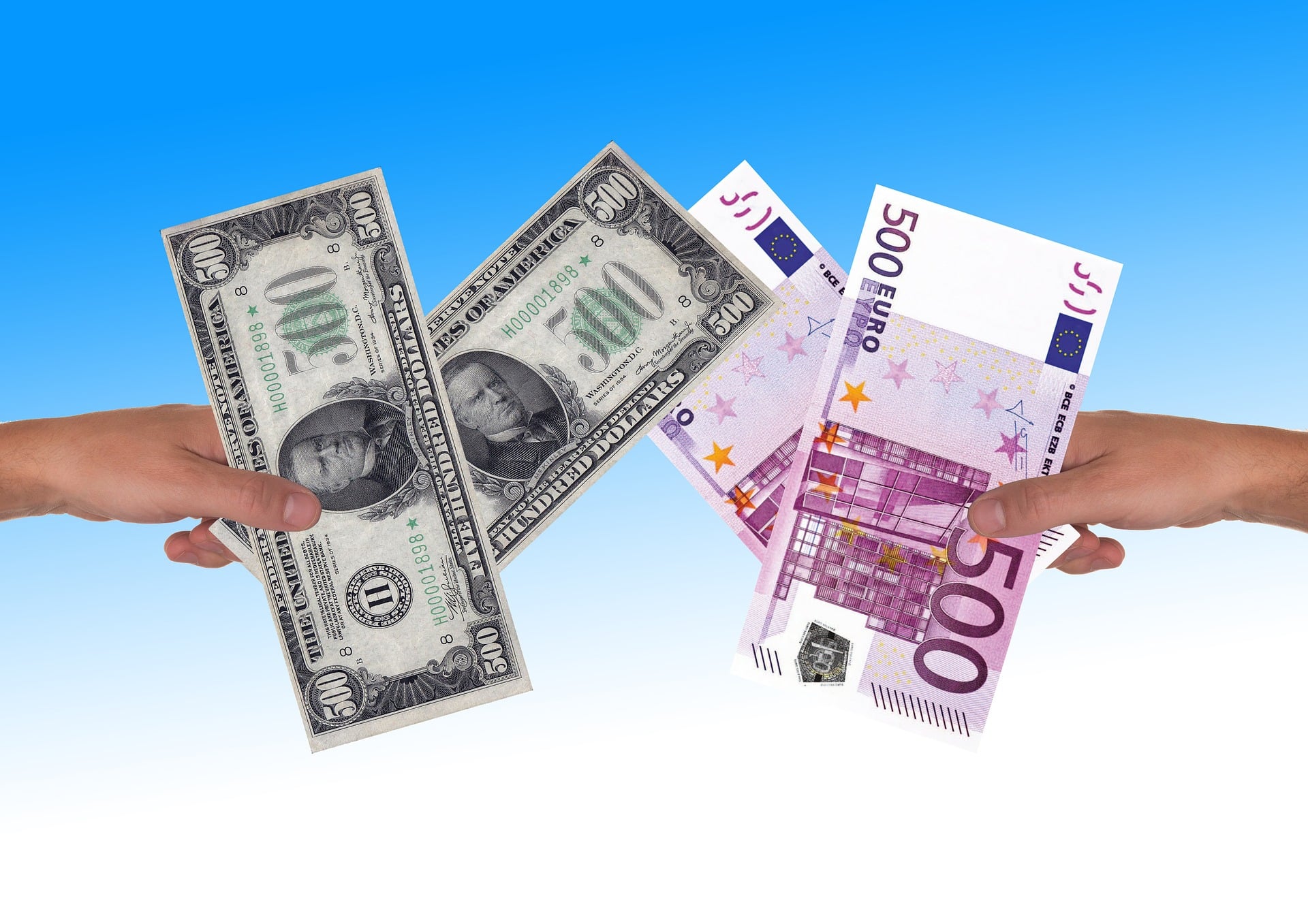 exchange rates are illustrated in this photo showing dollars to euros in two different hands