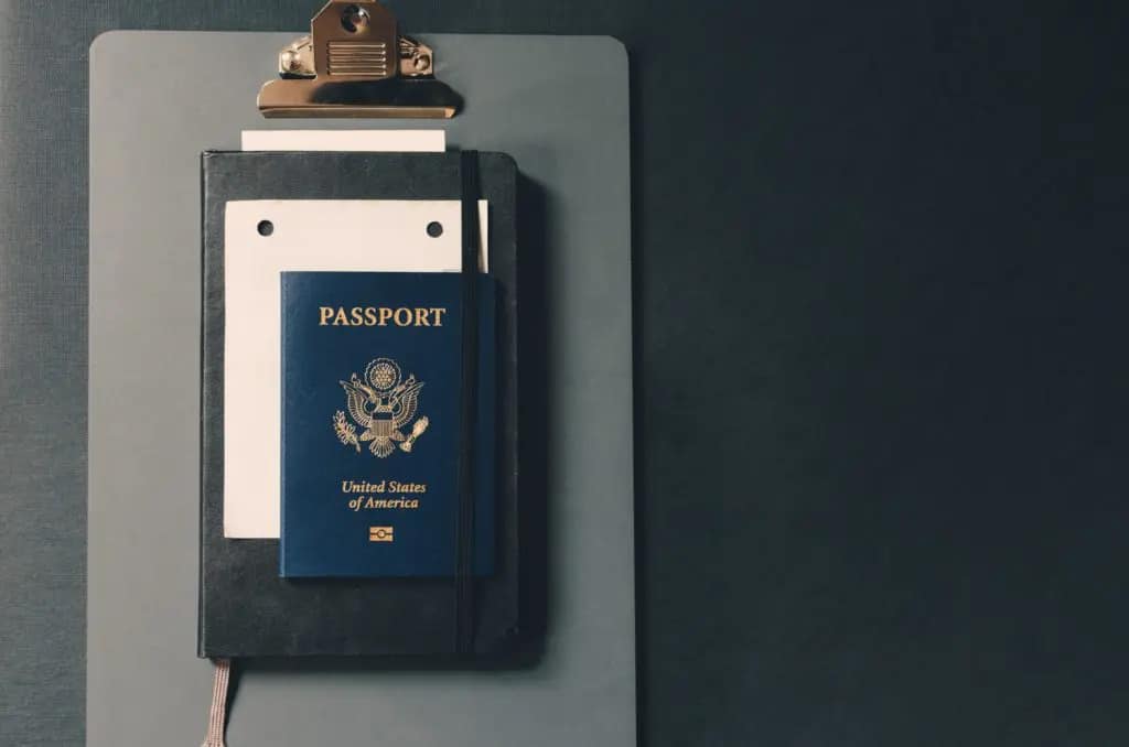 Proof of address documents: passport and notebook on a clipboard