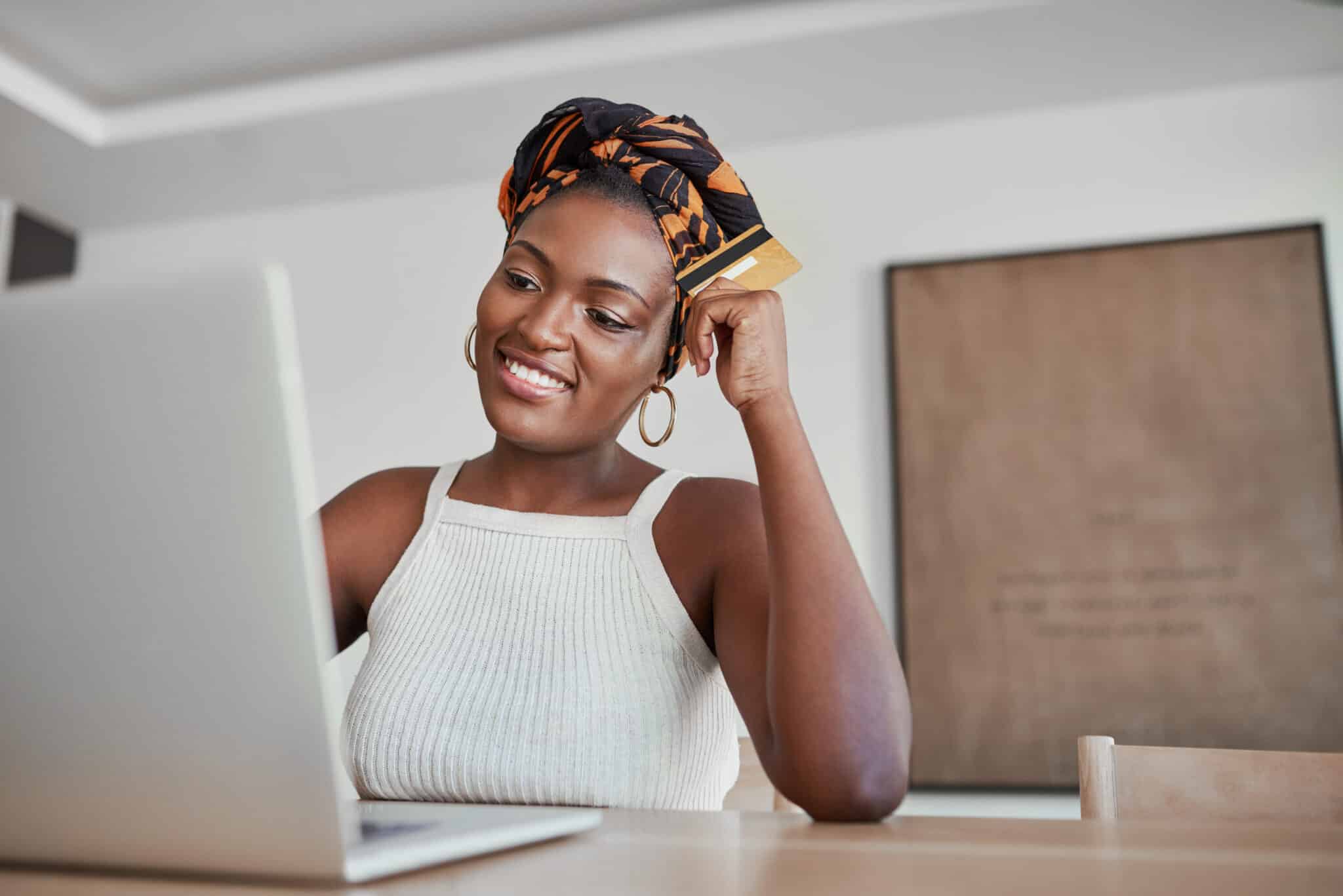 set a safe financial password like your remitly password like this african woman at a laptop