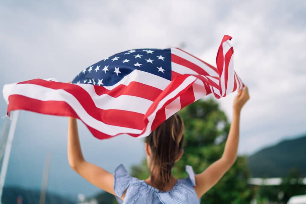 How to get an ITIN number: woman holding an American flag