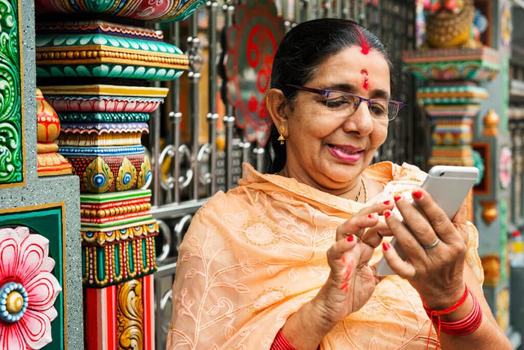 ICICI money to India: A woman in India uses her cellphone