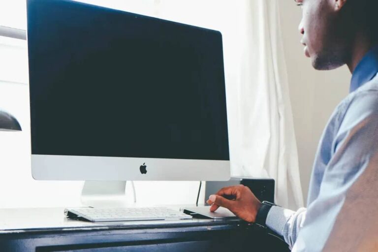 Why is it important to reconcile your bank statements: entrepreneur using a computer