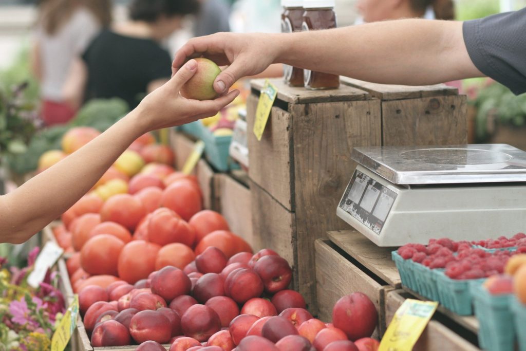 buying apples at the market with a world currency