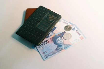 Indonesia currency: rupiah banknotes, wallet, and a passport