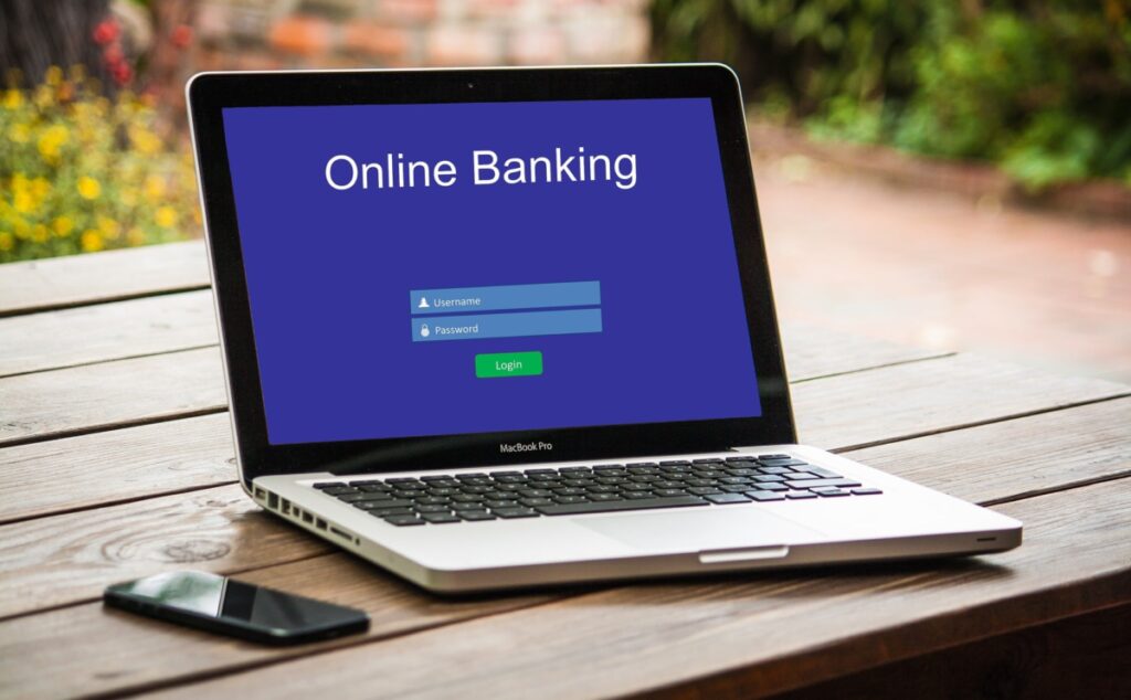 A laptop showing an online banking login screen