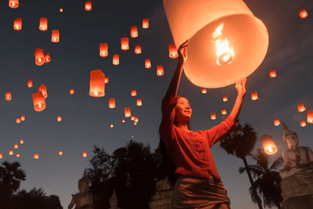 A woman releasing a lantern in Thailand