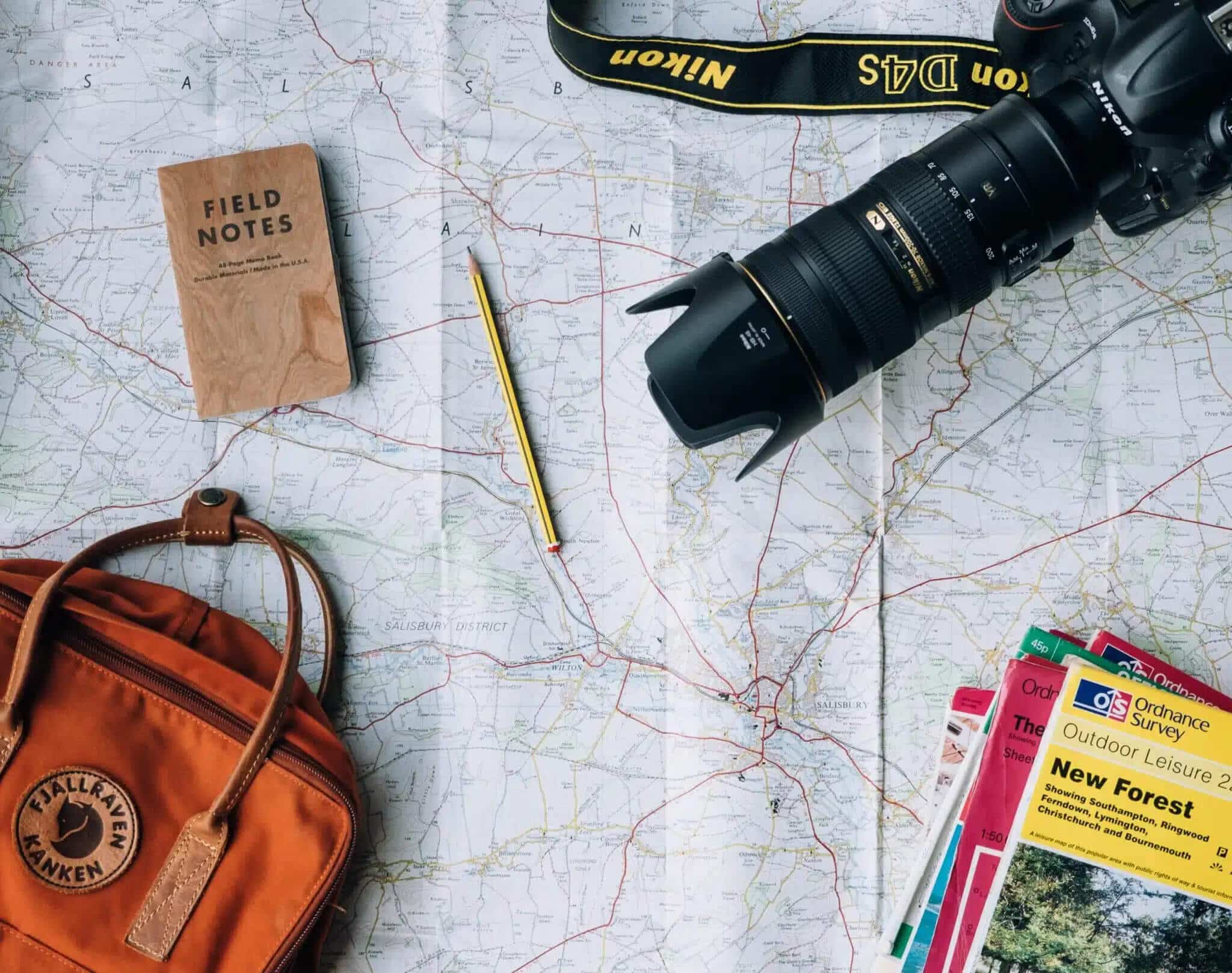 Map, bag, pencil, camera, and books
