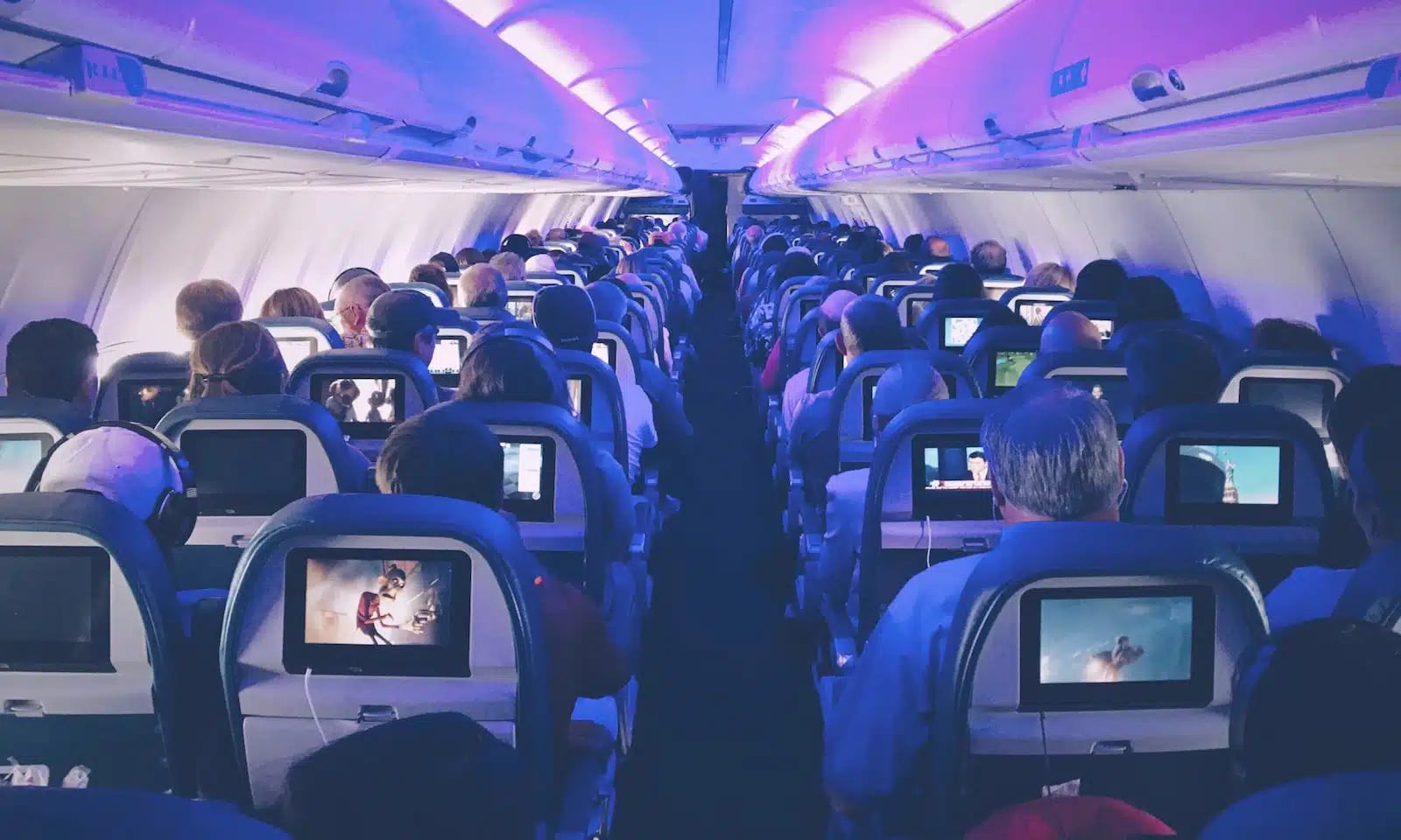 Cheap international flights: passengers watching movies in an airplane