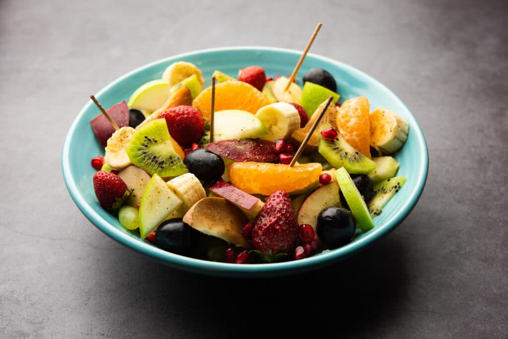 Fruit chaat in a bowl with spices eaten as a popular Ramadan food in South Asia.