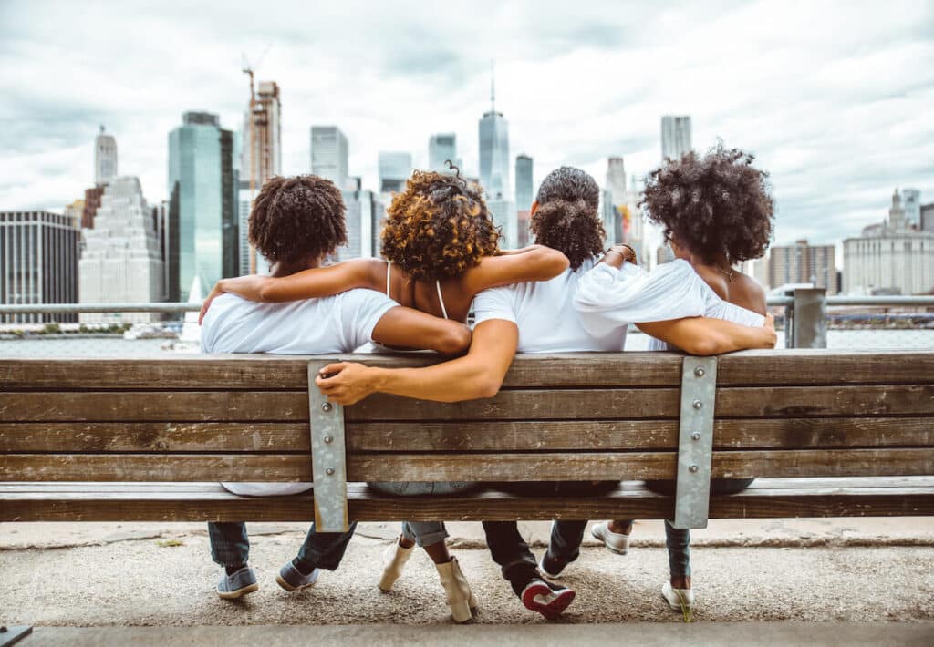 Lowest cost of living in US: group of friends sitting on a bench