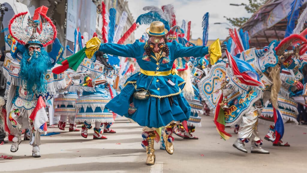 People wearing costumes while dancing at a Bolivian carnival