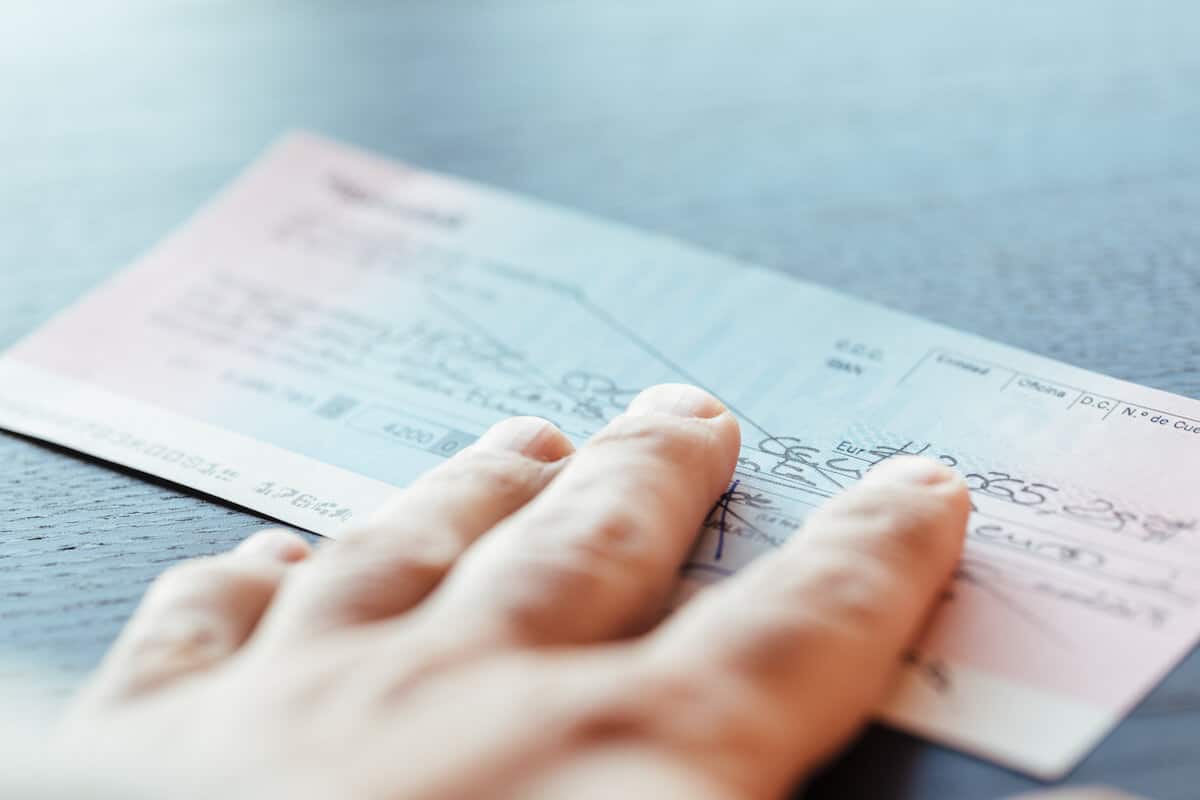 How long does it take a check to clear: person holding a check