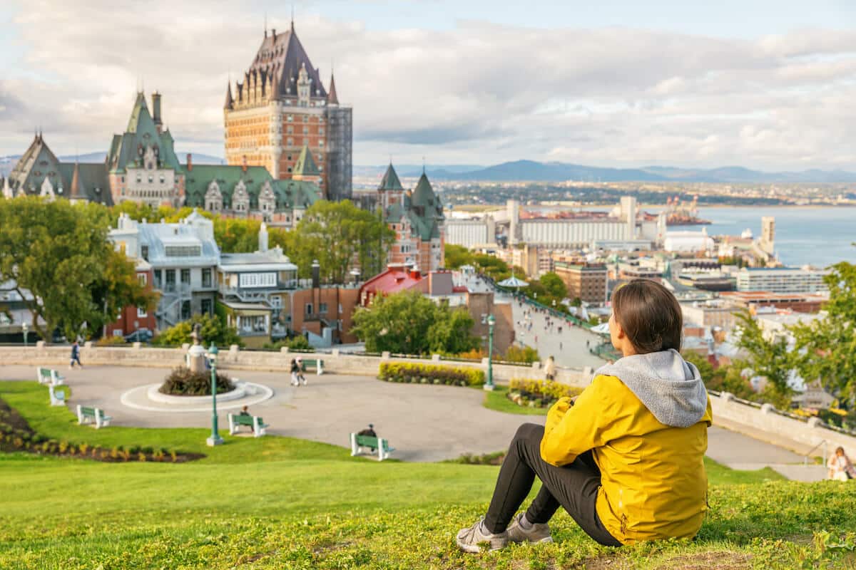 Cost of living in Canada: person looking at the view of Chateau Frontenac castle and the St. Lawrence river