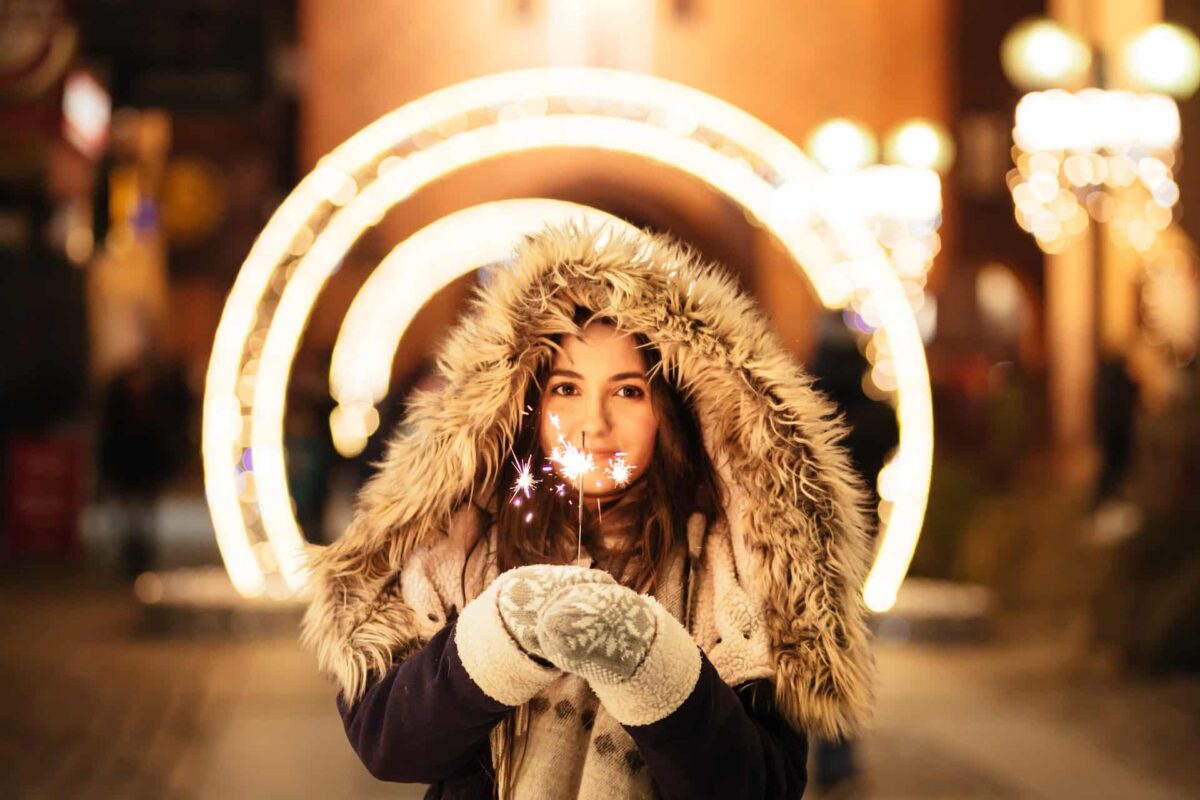 Woman holding a candle during Winter Holidays