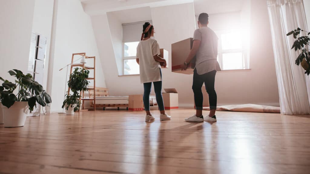 How to move to another country: couple carrying boxes into their new home