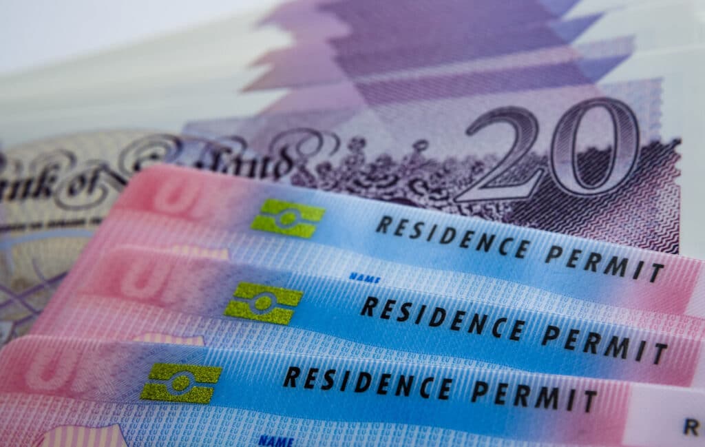 How to get a work visa in the UK: UK Residence Permit cards and £20 bills