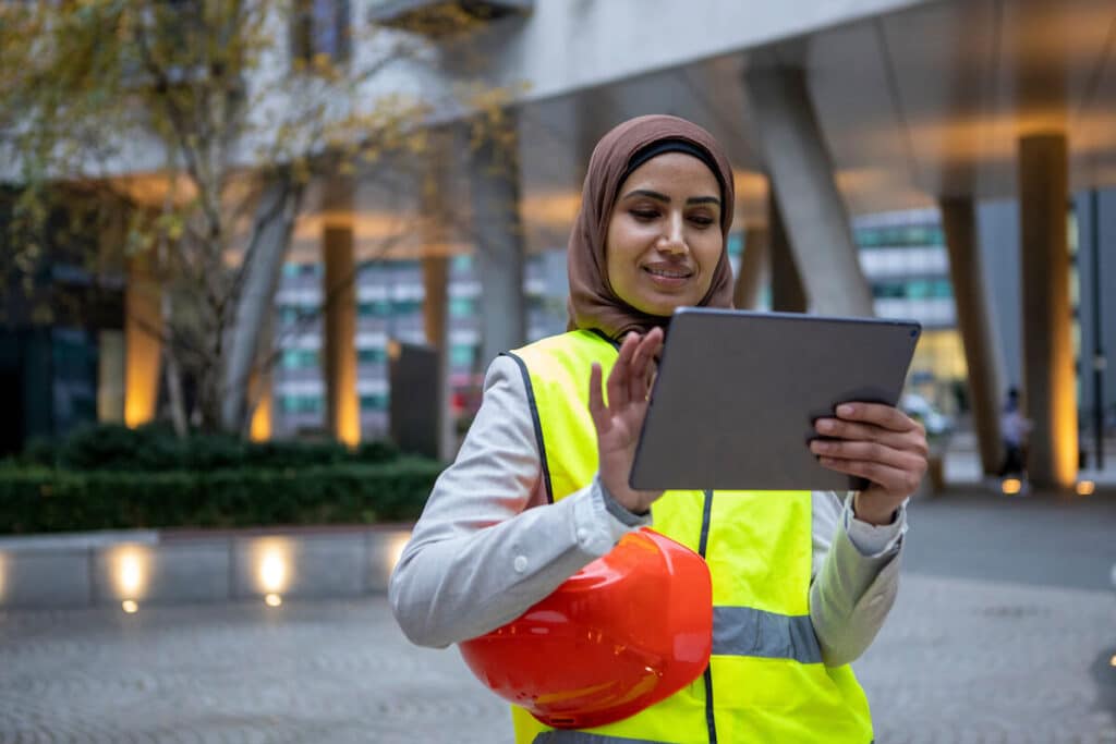 Engineer wearing a hijab and using a tablet