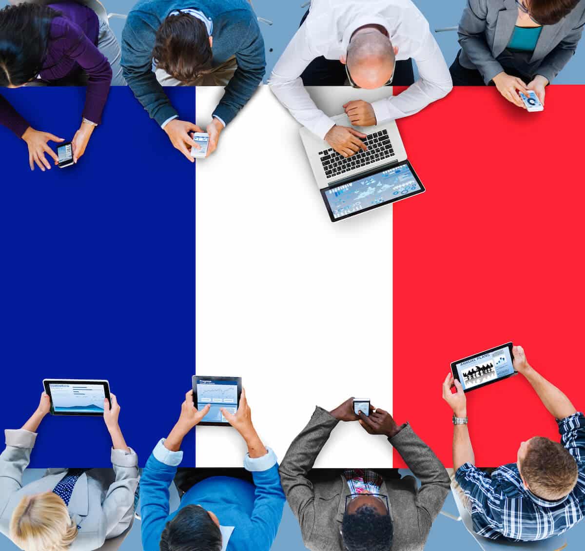 French working visas: group of people working at a table that's painted like the French flag