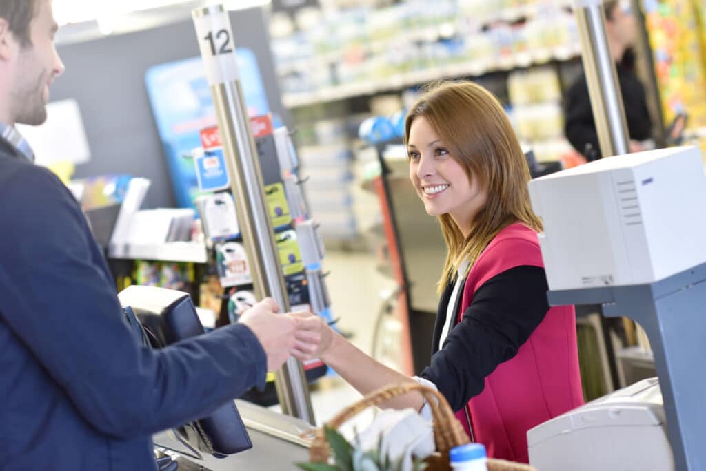 Cashier happily receiving a customer's payment