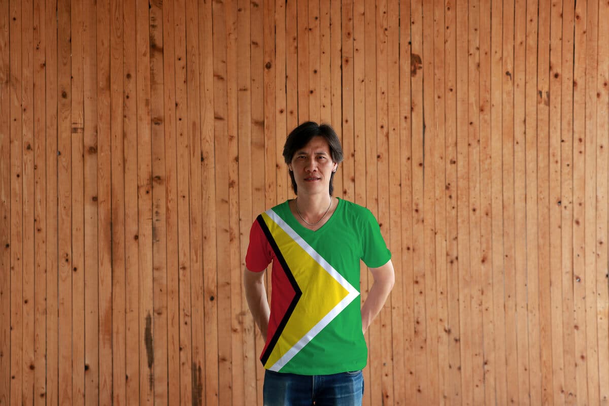 Man wearing a Guyana flag themed shirt