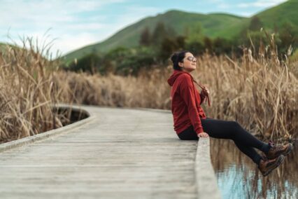 Living in New Zealand: woman sitting on a concrete walkway