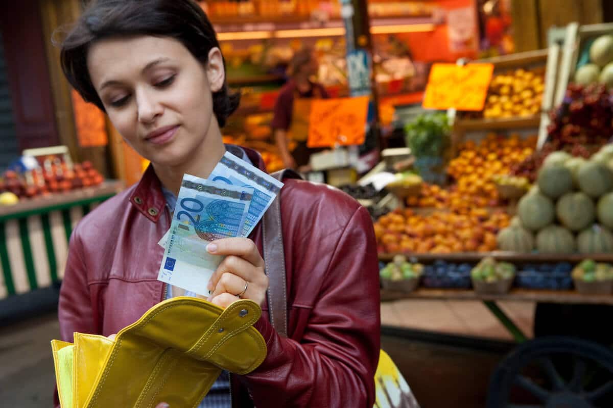 What countries use the euro: woman getting bills from her wallet