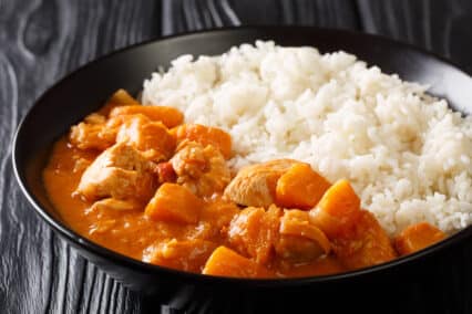 a bowl of domoda peanut stew with rice