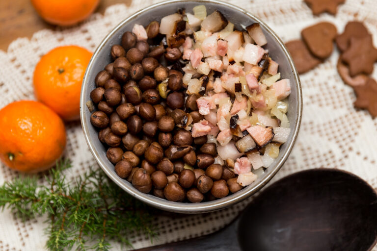 a bowl of gray peas with bacon