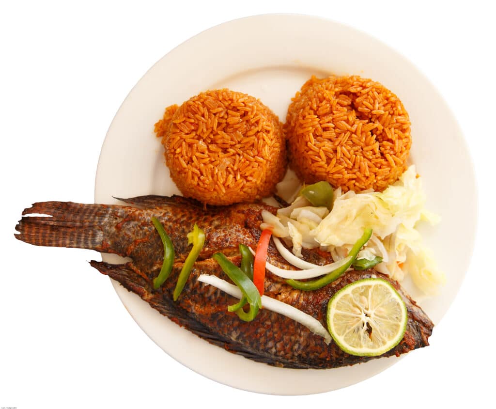 ghanaian jollof rice is on a plate with fish