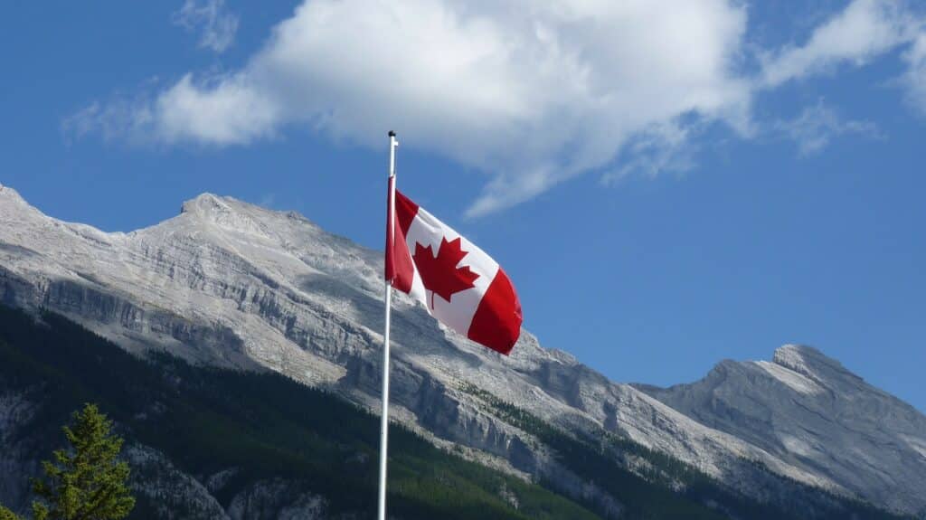 Bandera de Canadá en un paisaje montañoso