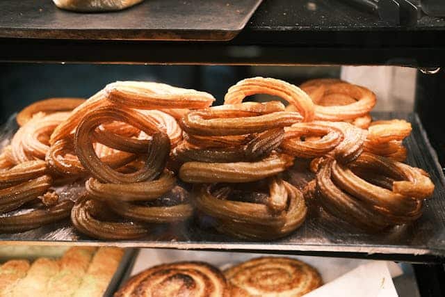 Freshly prepared churros ready on a rack