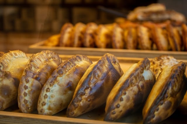 Empanadas lined up freshly cooked