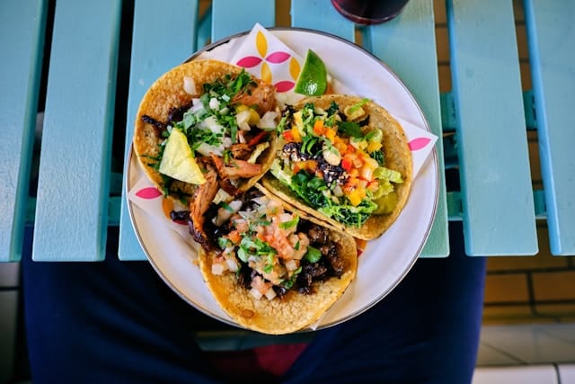 Three filled tacos on a plate