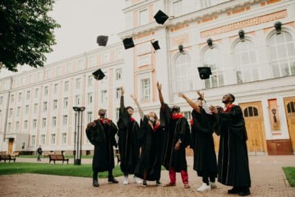 Students celebrating graduation on a scool campus